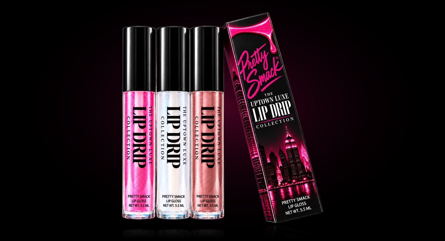 The Uptown Luxe Lip Drip collection box with three gloss tubes in shimmering hot pink, iridescent sheer and rose bronze